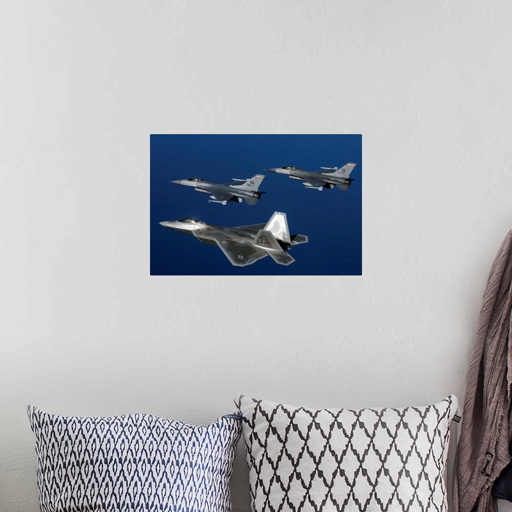 A bohemian room featuring Three F-22A Raptor aircrafts fly in formation.