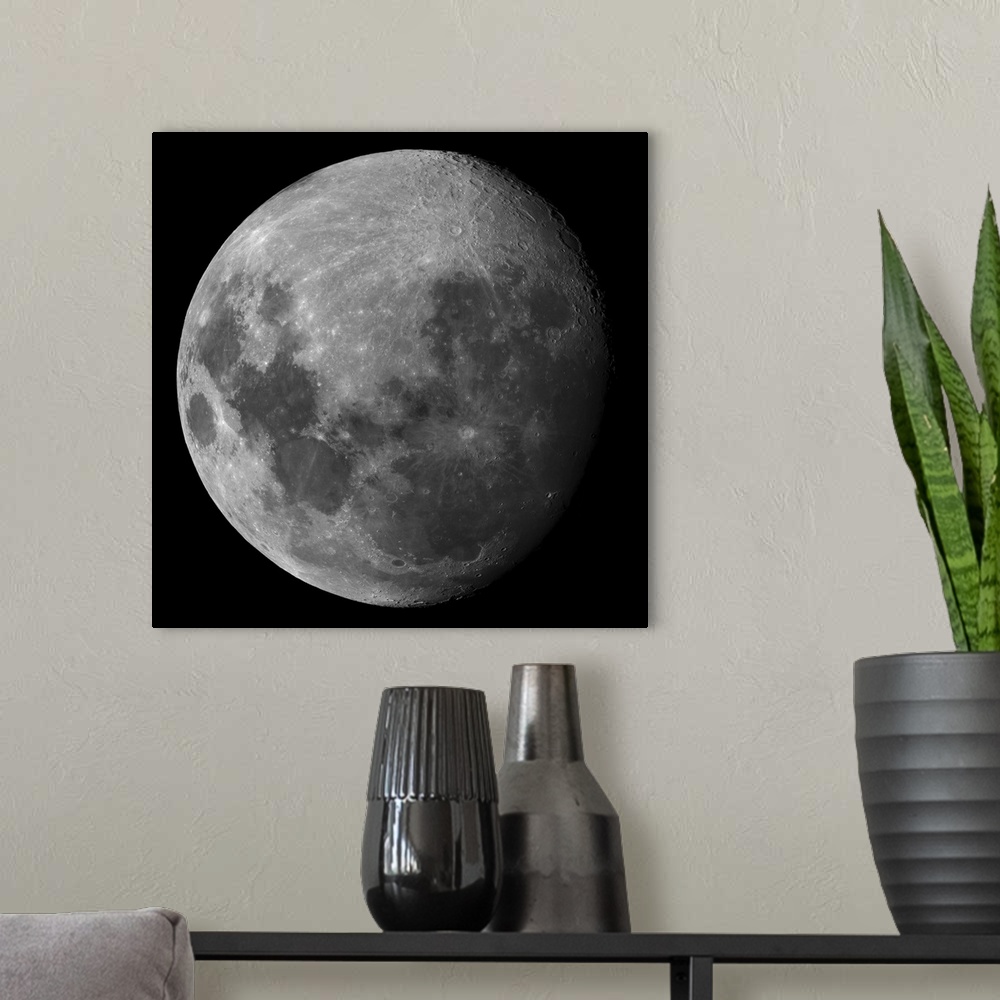 A modern room featuring Big canvas print of an up close view of the moon where you can see the details of the craters.
