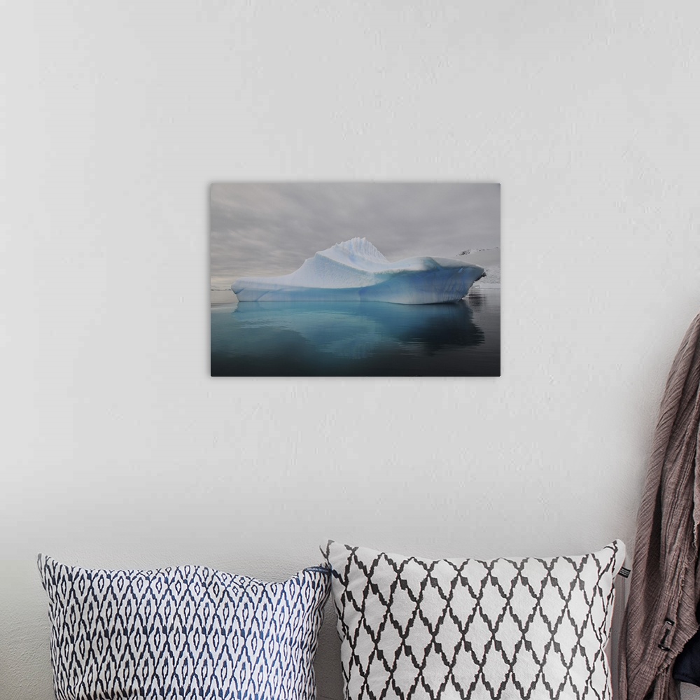 A bohemian room featuring Translucent blue iceberg reflection, Antarctica.