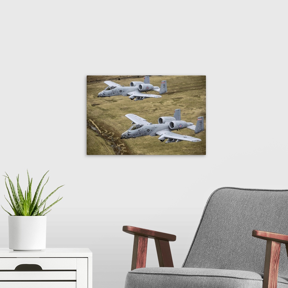 A modern room featuring December 30, 2013 - Two A-10 Thunderbolt II's conduct a training mission over Razorback Range at ...