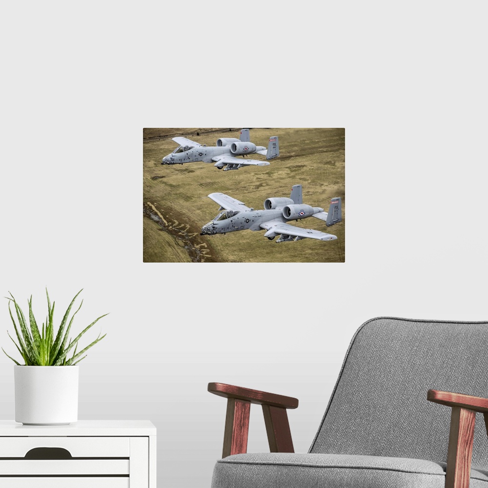 A modern room featuring December 30, 2013 - Two A-10 Thunderbolt II's conduct a training mission over Razorback Range at ...