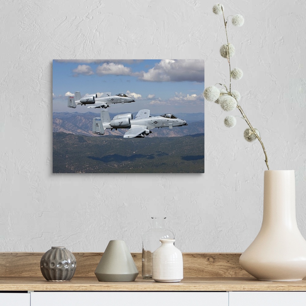 A farmhouse room featuring Two A-10 Thunderbolt's from the 124th Fighter Wing's 190th Fighter Squadron fly over the mountain...