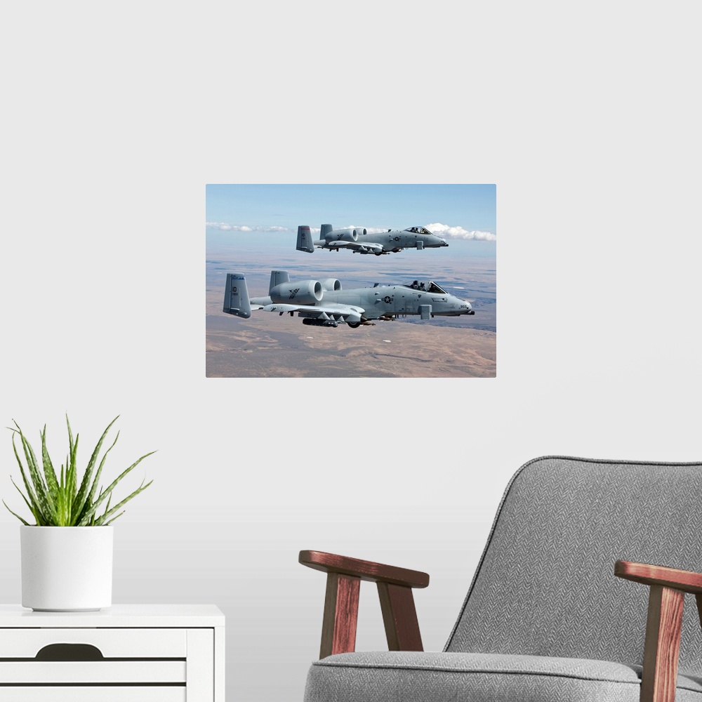 A modern room featuring Two A-10 Thunderbolt's from the 124th Fighter Wing fly over the Saylor Creek bombing range in Cen...
