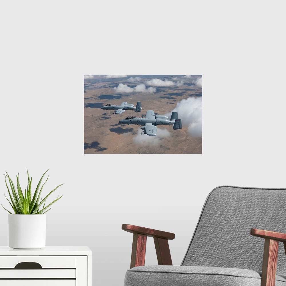 A modern room featuring Two A-10 Thunderbolt's from the 124th Fighter Wing's 190th Fighter Squadron fly over the Saylor C...