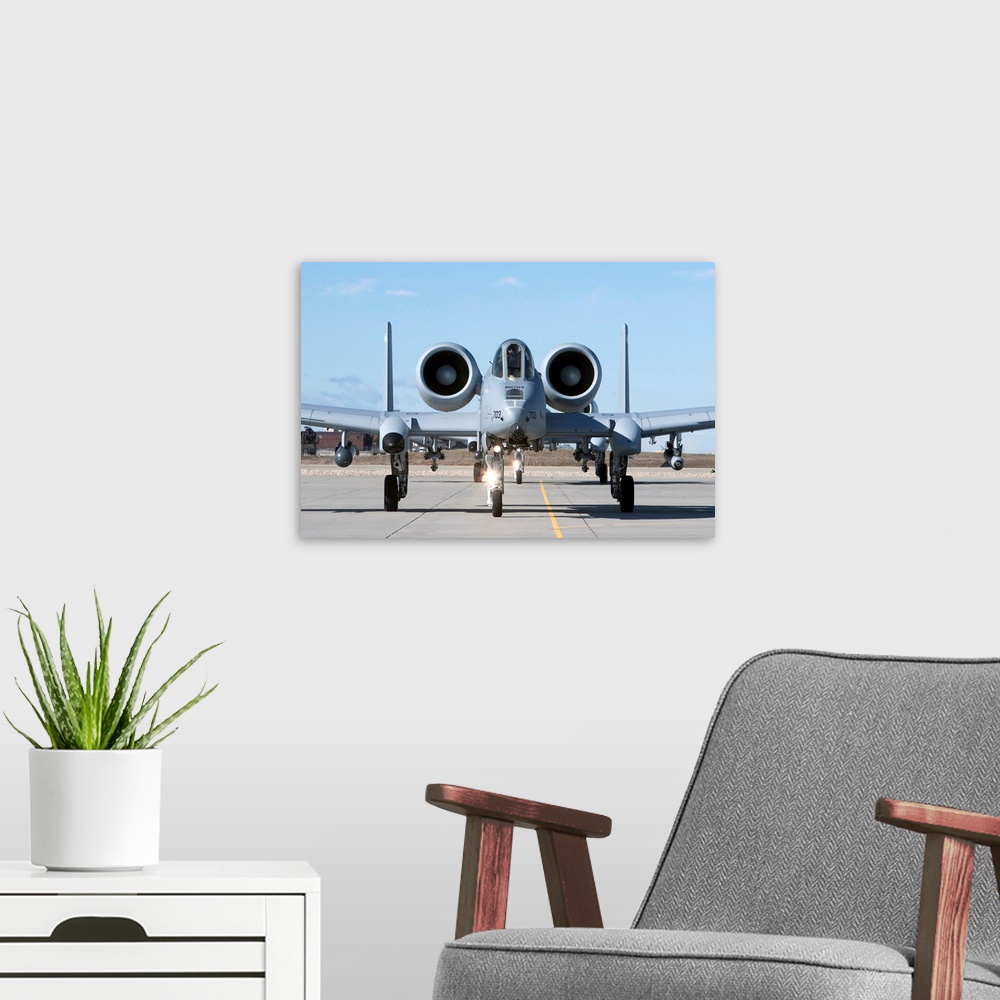 A modern room featuring Two A-10 Thunderbolt's from the 190th Fighter Squadron taxi to the runway on a training mission o...