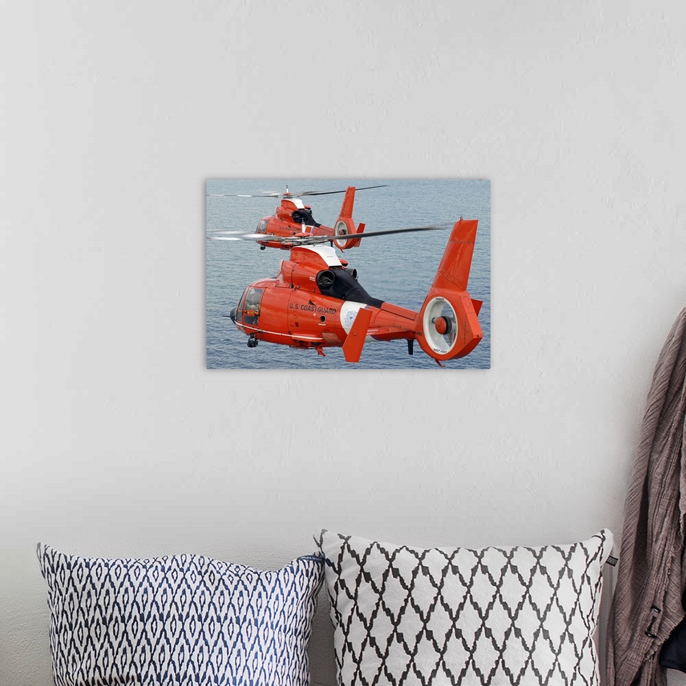 A bohemian room featuring Two Coast Guard HH-65C Dolphin helicopters from Air Station Miami fly in formation over the Atlan...