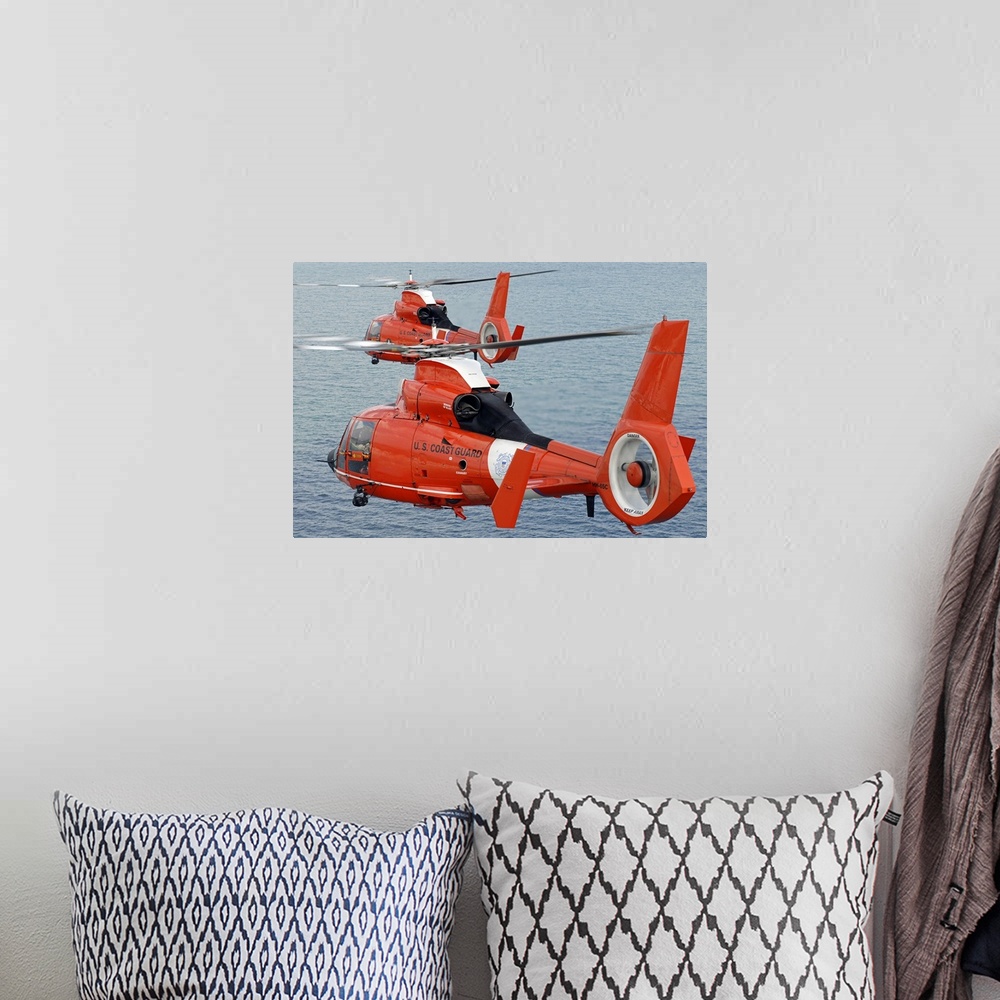 A bohemian room featuring Two Coast Guard HH-65C Dolphin helicopters from Air Station Miami fly in formation over the Atlan...