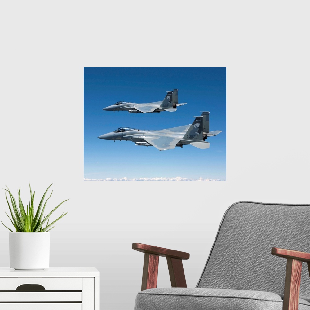 A modern room featuring Two F-15 Eagles from the 173rd Fighter Wing conduct air-to-air training over Central Oregon.