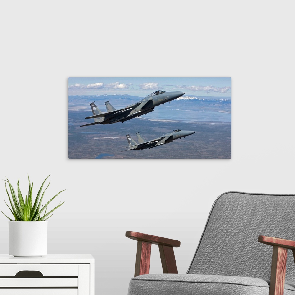 A modern room featuring Two F-15 Eagles from the 173rd Fighter Wing conduct air-to-air training over Central Oregon.