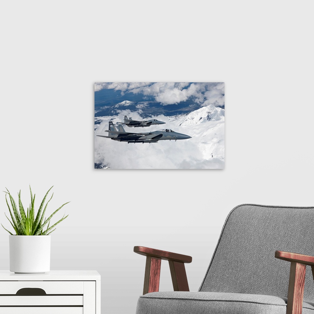 A modern room featuring Two F-15 Eagles from the 173rd Fighter Wing fly past snow capped peaks in Central Oregon.