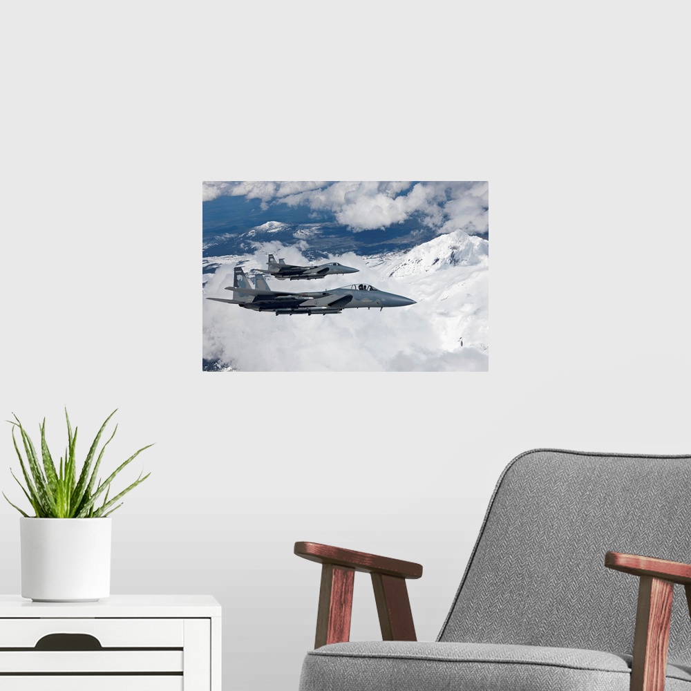 A modern room featuring Two F-15 Eagles from the 173rd Fighter Wing fly past snow capped peaks in Central Oregon.