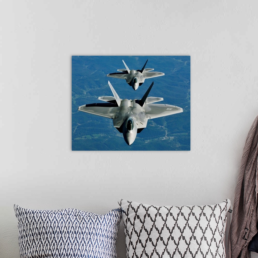A bohemian room featuring Two F-15's fly in formation behind a KC-10 Extender.