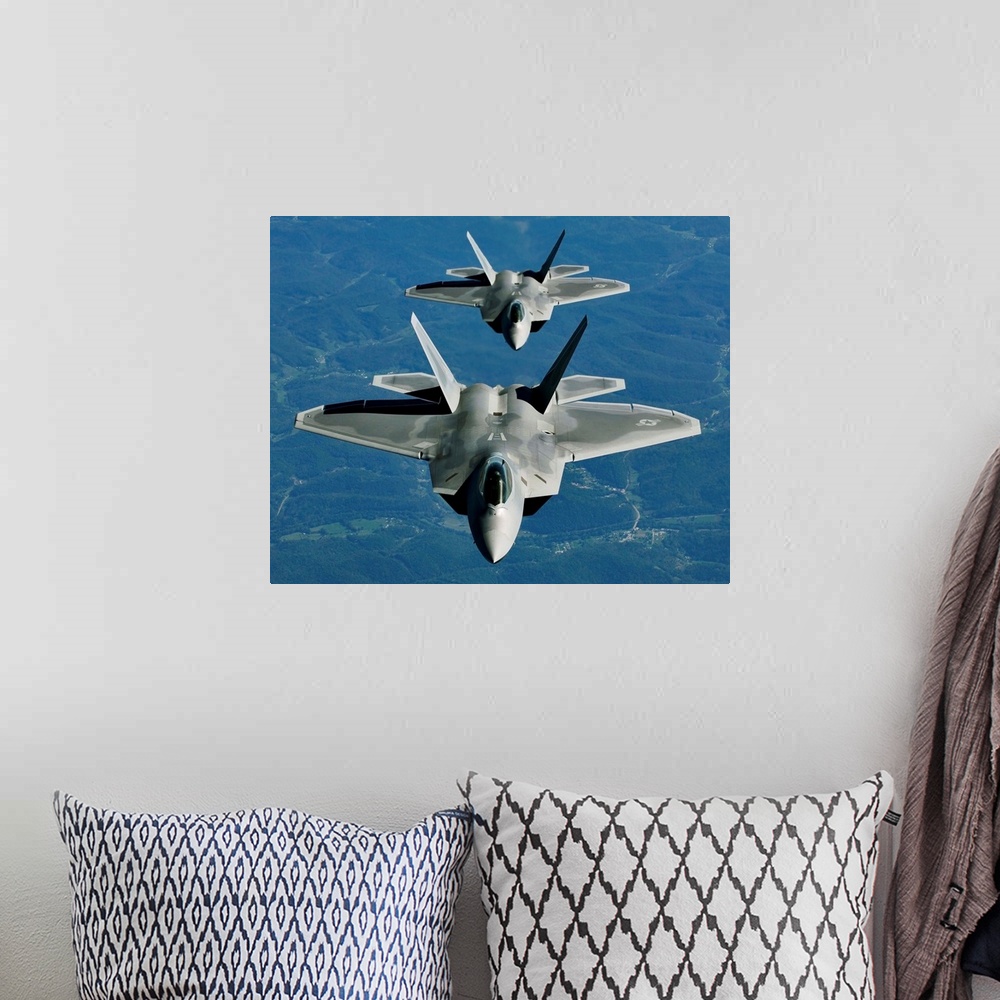 A bohemian room featuring Two F-15's fly in formation behind a KC-10 Extender.