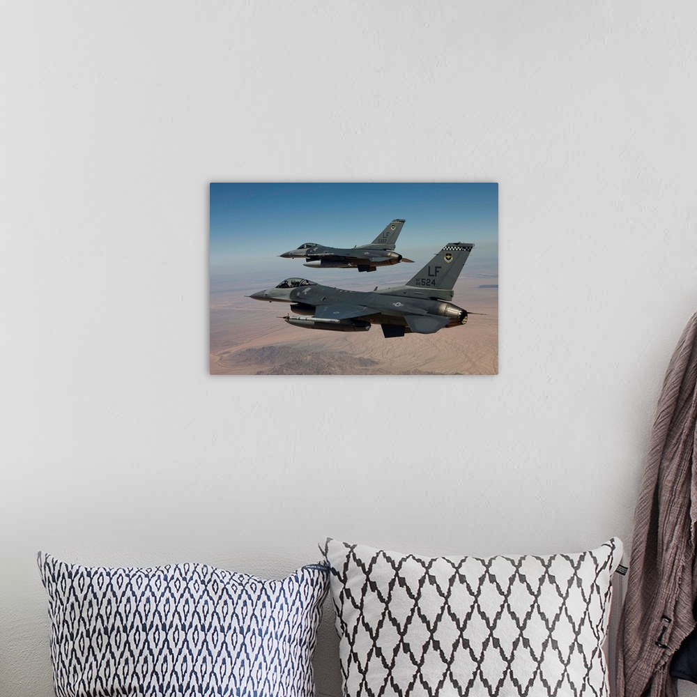 A bohemian room featuring Two F-16's from the 56th Fighter Wing at Luke Air Force Base, Arizona, fly in formation over Ariz...