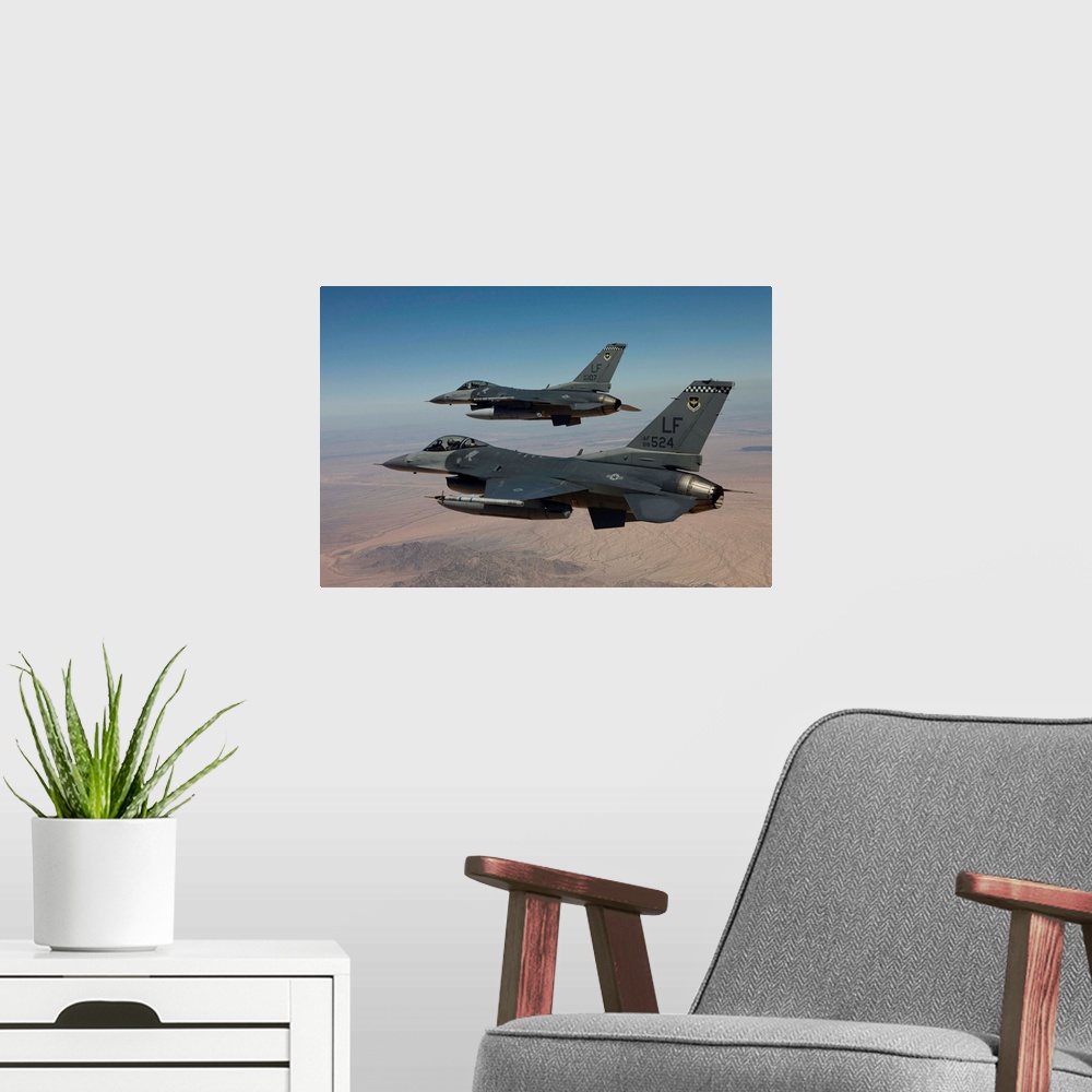 A modern room featuring Two F-16's from the 56th Fighter Wing at Luke Air Force Base, Arizona, fly in formation over Ariz...