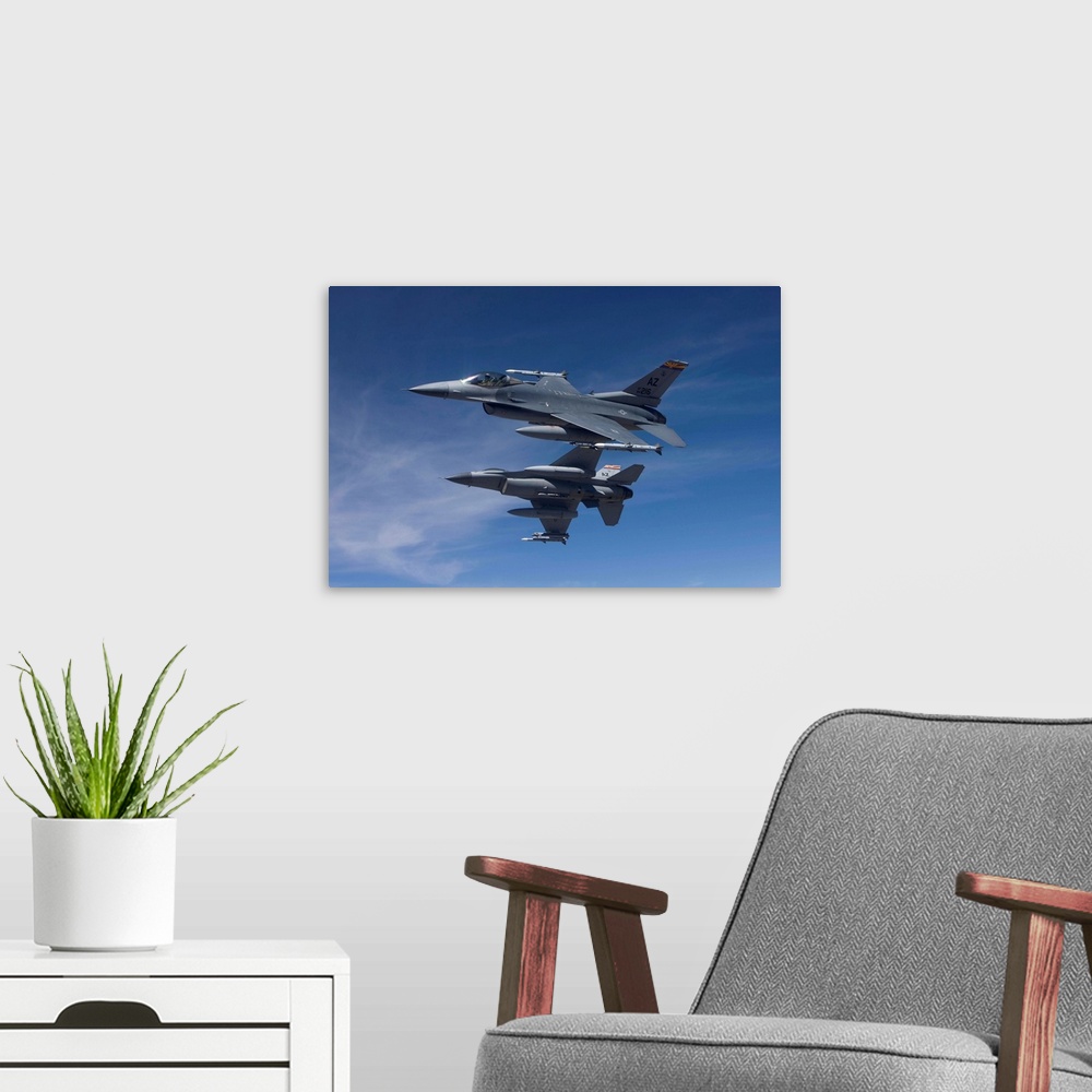 A modern room featuring Two F-16's from the 162nd Fighter Wing manuever on an air-to-air training mission.