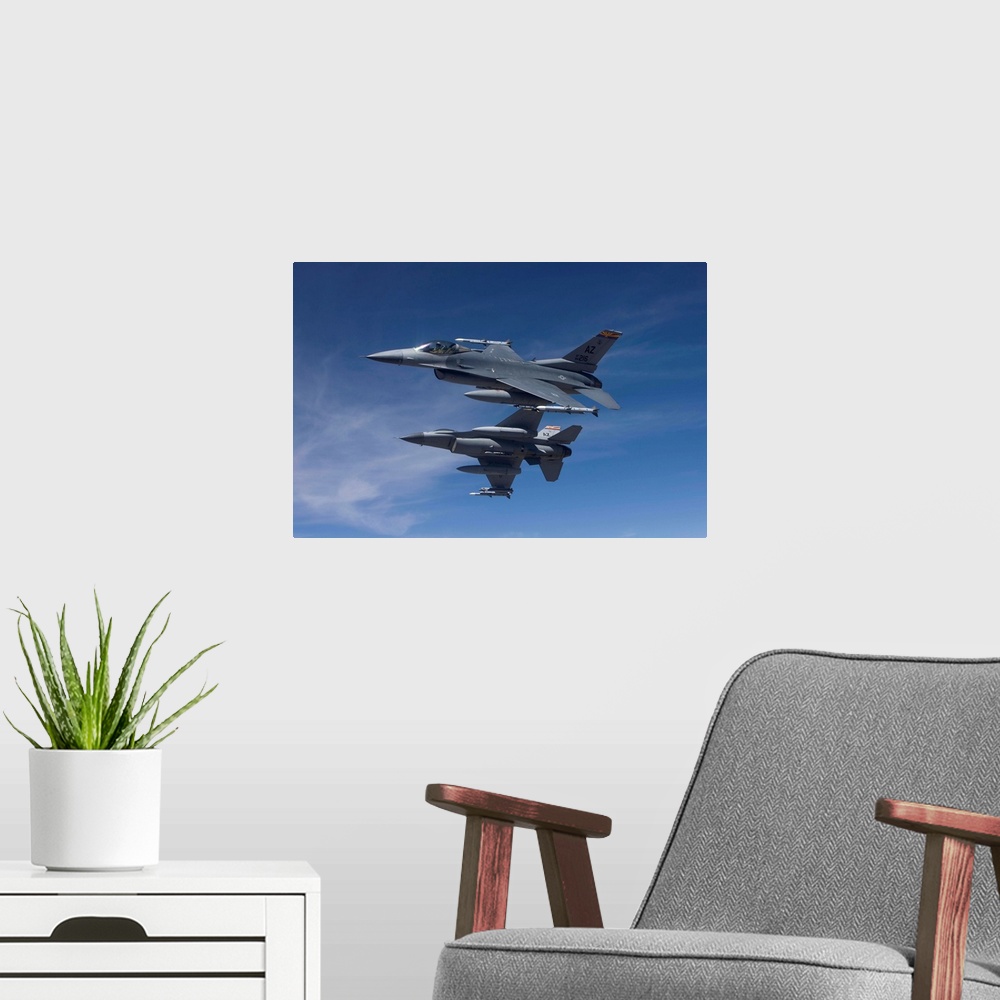 A modern room featuring Two F-16's from the 162nd Fighter Wing manuever on an air-to-air training mission.