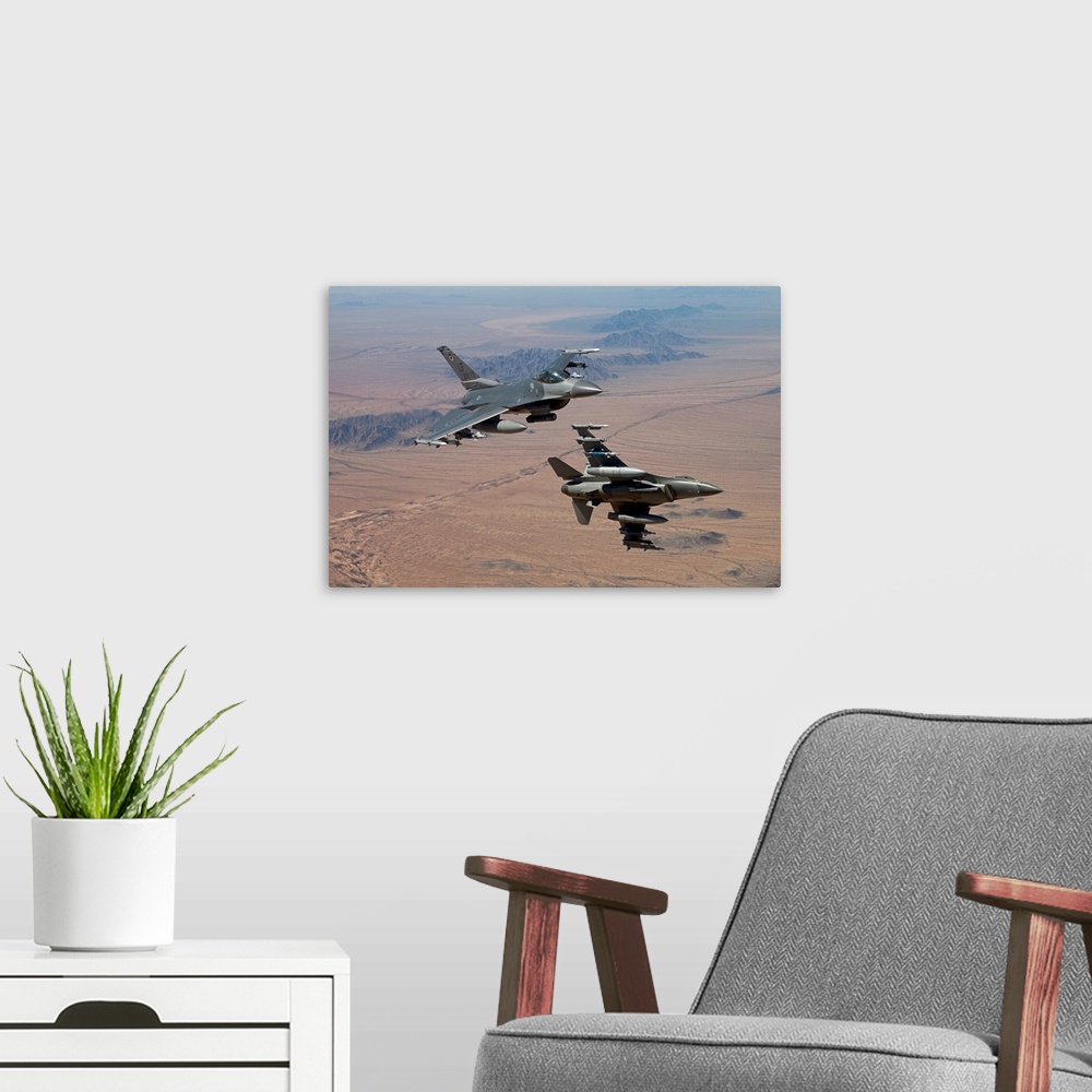 A modern room featuring Two F-16's from the 56th Fighter Wing at Luke Air Force Base, Arizona, manuever on a training mis...