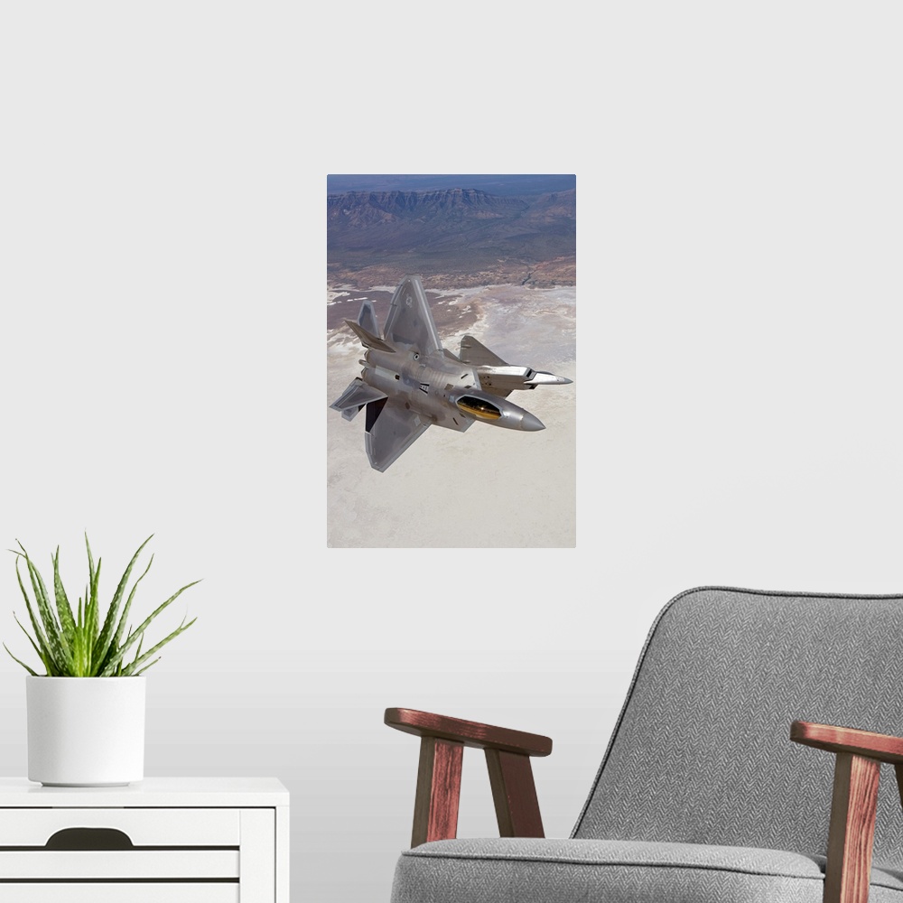 A modern room featuring Two F-22 Raptors from the 49th Fighter Wing manuever while on a training mission out of Holloman ...