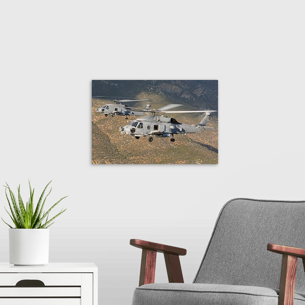 A modern room featuring Two MH-60 helicopters of the U.S. Navy Blue Hawks squadron flying over Fallon, Nevada.