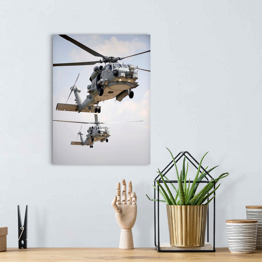 A bohemian room featuring Two multi-mission MH-60R Sea Hawk helicopters fly in tandem.