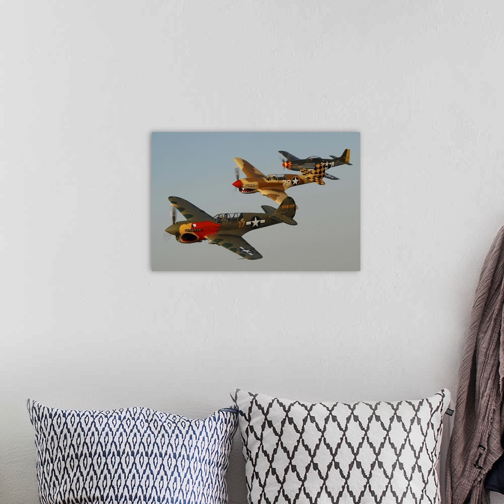 A bohemian room featuring Two P-40 Warhawks and a P-51D Mustang flying over Chino, California.