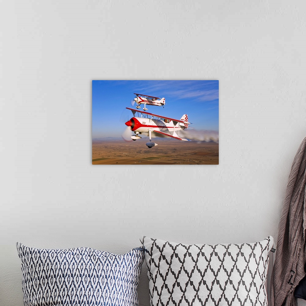 A bohemian room featuring Two Pitts Model 12 aircraft in flight over Chandler, Arizona.