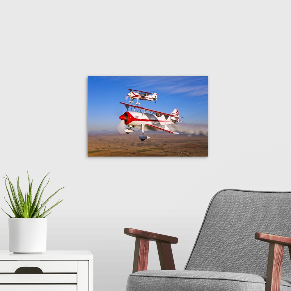 A modern room featuring Two Pitts Model 12 aircraft in flight over Chandler, Arizona.