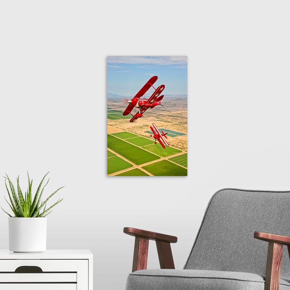 A modern room featuring Two Pitts Special S-2A aerobatic biplanes in flight near Chandler, Arizona.