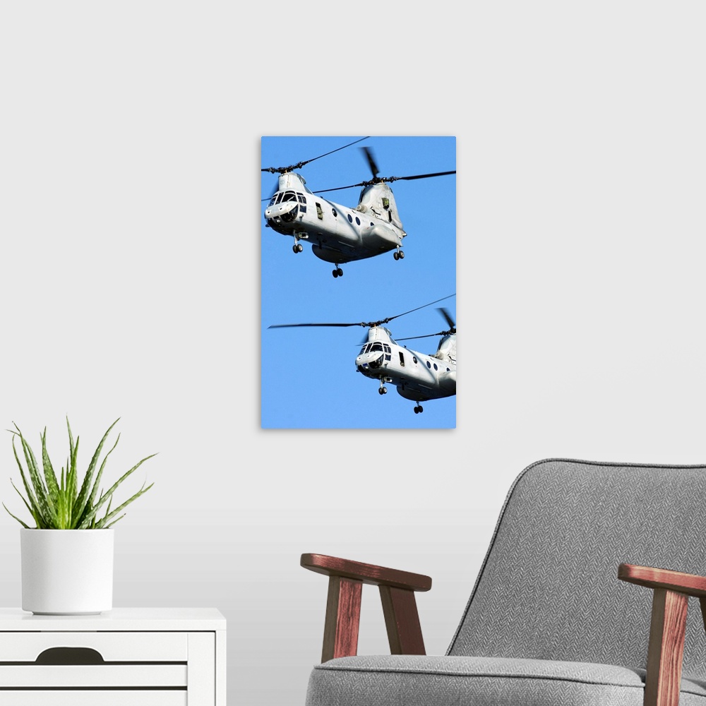 A modern room featuring November 9, 2010 - Two U.S. Marine Corps CH-46E Sea Knight helicopters fly near the amphibious as...