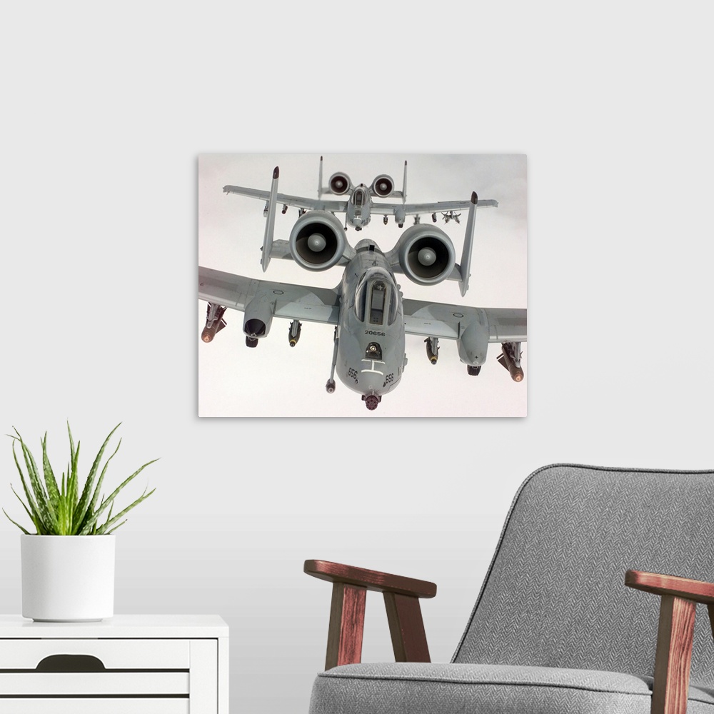 A modern room featuring Two US Air Force A10A Warthogs in flight