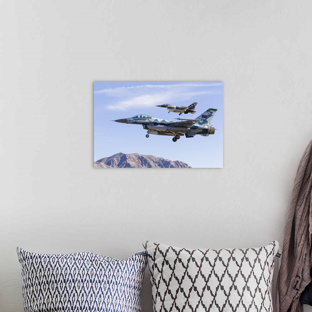 A bohemian room featuring Two U.S. Air Force F-16 Fighting Falcon aggressor aircraft on final approach.