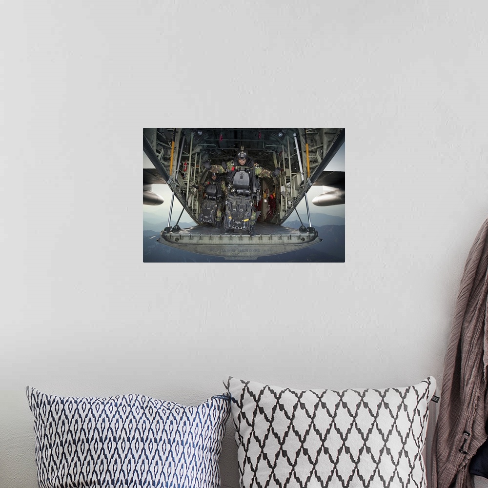 A bohemian room featuring Landscape photograph of a U.S. Navy SEAL combat diver, loaded with gear, preparing to jump from t...