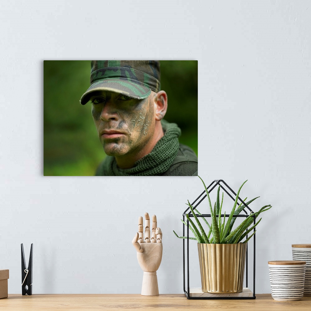 A bohemian room featuring Close-up view of a U.S. Special Forces soldier with camouflage face paint.