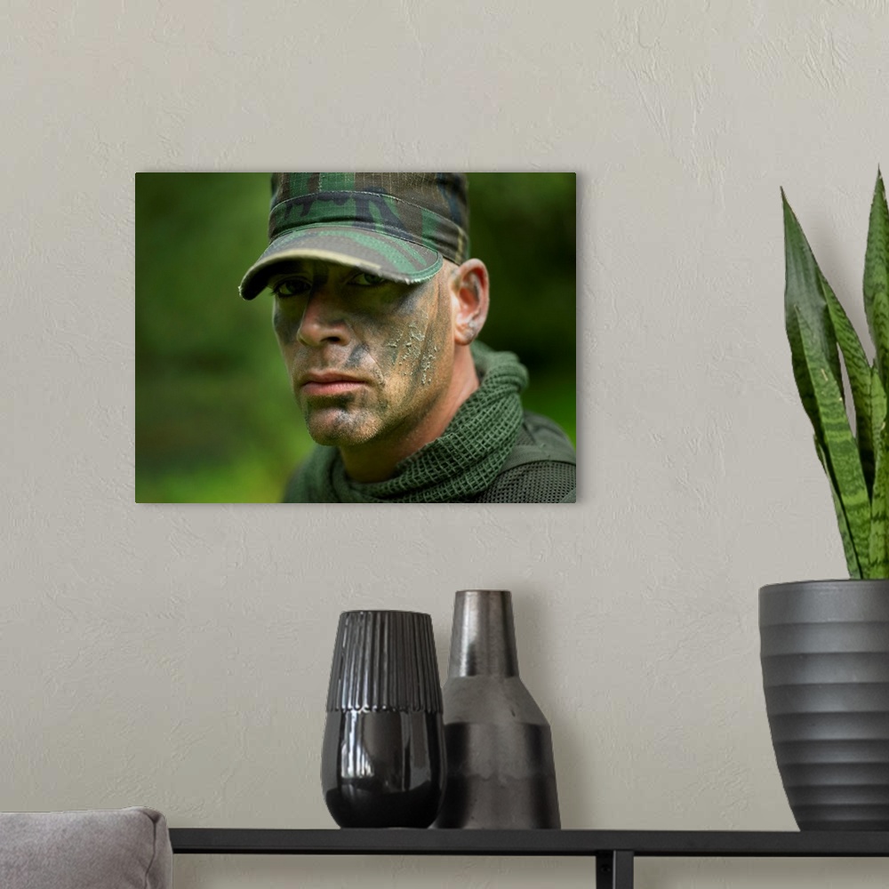 A modern room featuring Close-up view of a U.S. Special Forces soldier with camouflage face paint.