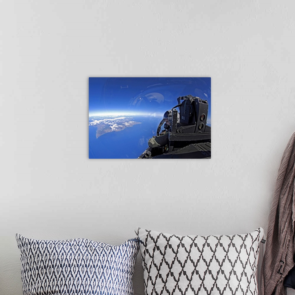A bohemian room featuring US Air Force captain looks out over the sky in a F15 Eagle