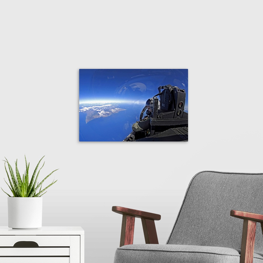 A modern room featuring US Air Force captain looks out over the sky in a F15 Eagle