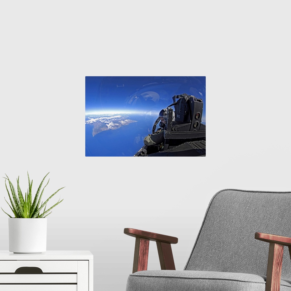 A modern room featuring US Air Force captain looks out over the sky in a F15 Eagle
