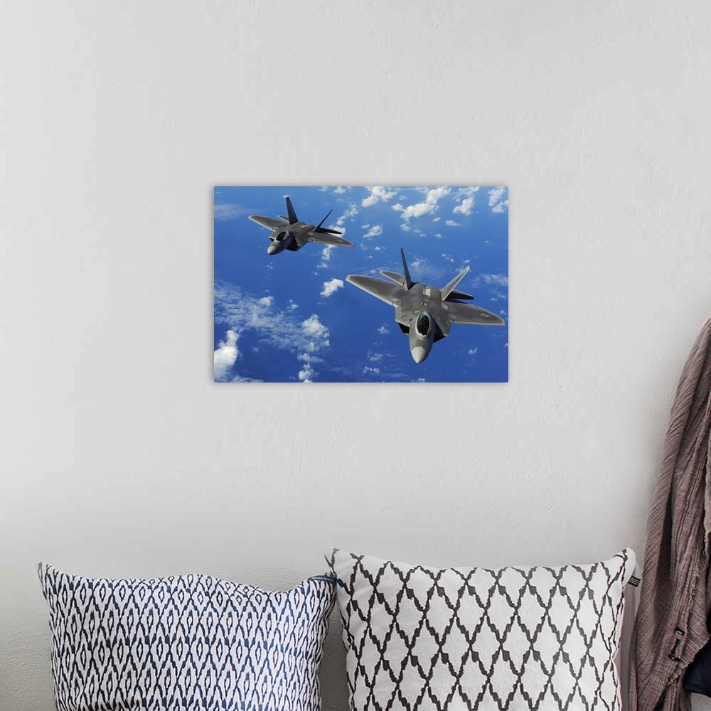A bohemian room featuring U.S. Air Force F-22 Raptors in flight near Guam.