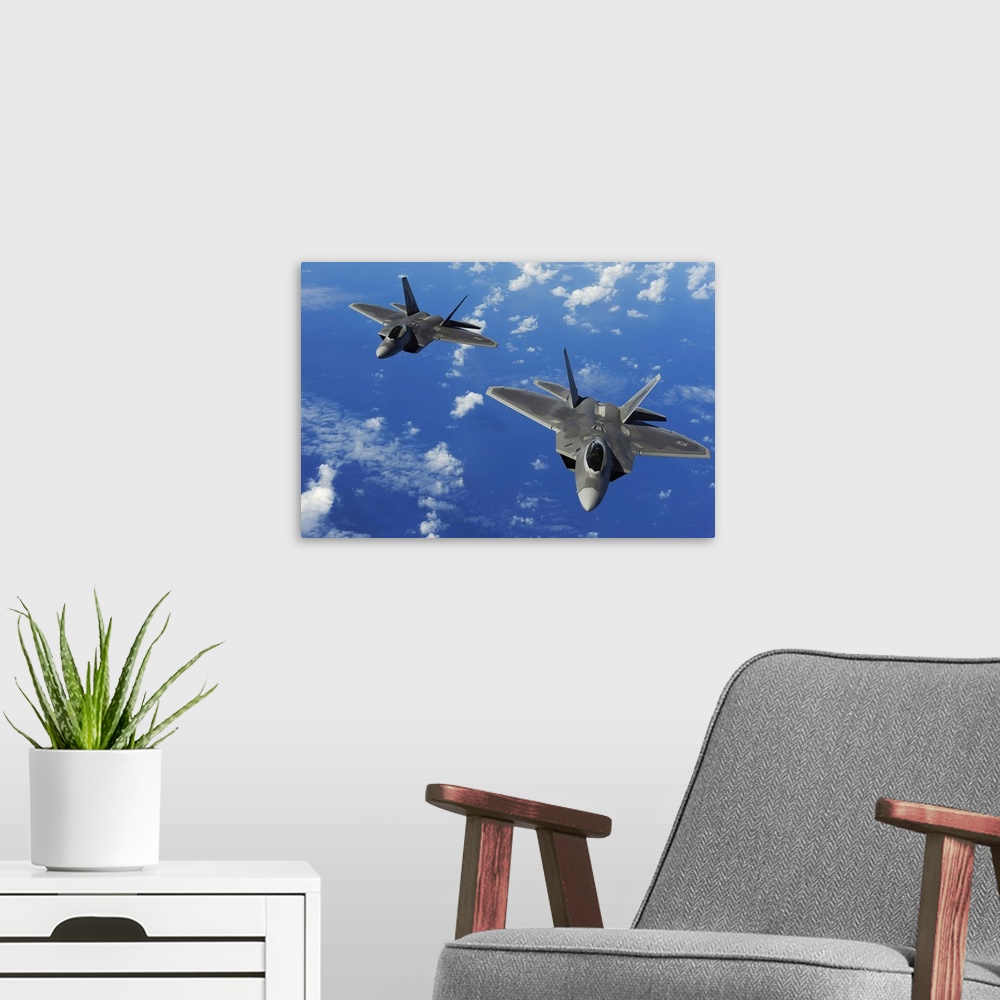 A modern room featuring U.S. Air Force F-22 Raptors in flight near Guam.