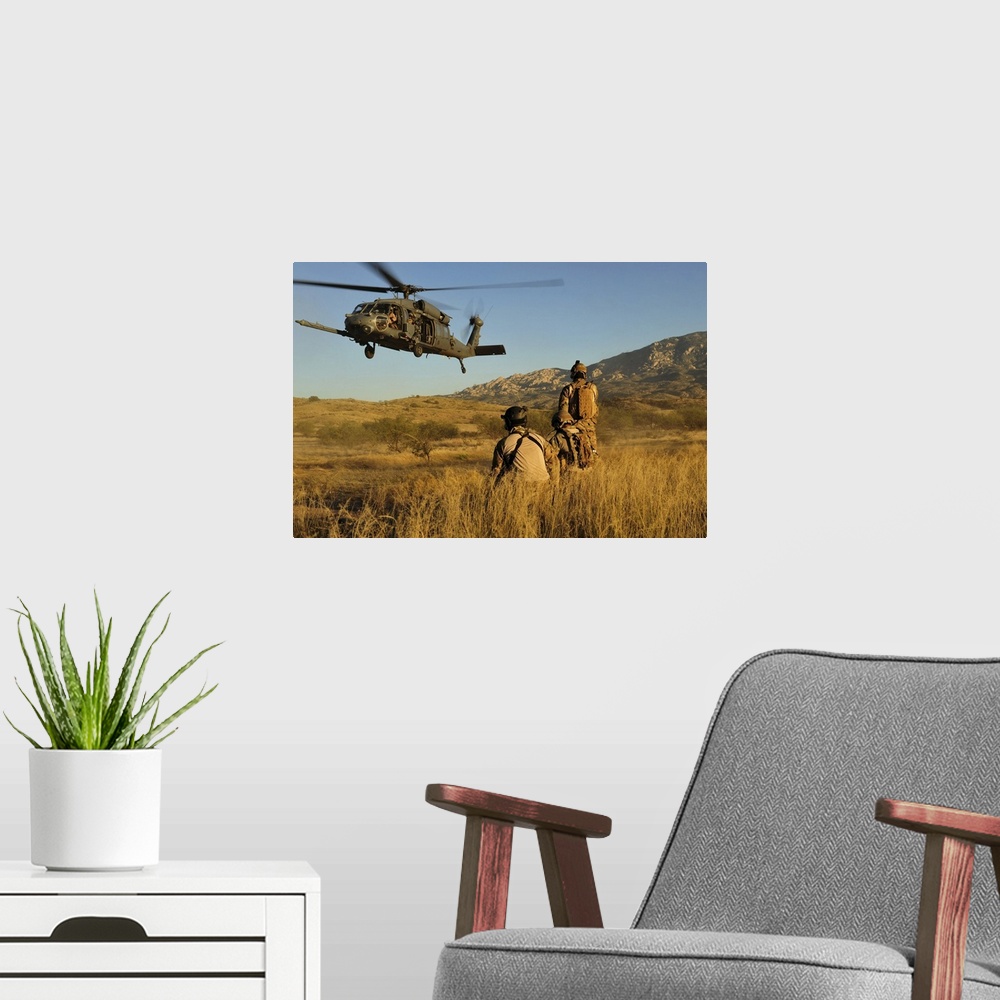 A modern room featuring October 18, 2011 - U.S. Air Force pararescuemen signal in a HH-60 Pave Hawk helicopter for extrac...