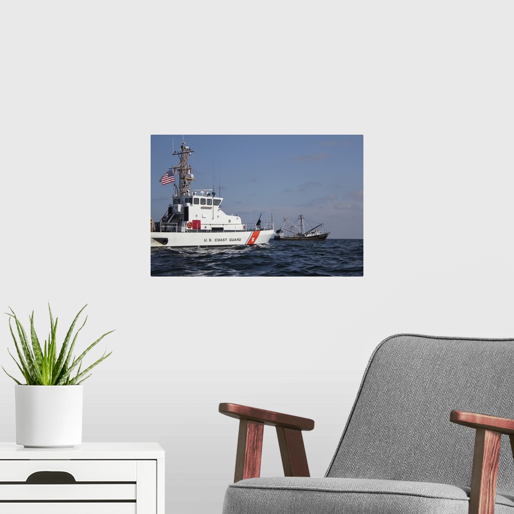 A modern room featuring June 21, 2010 - The U.S. Coast Guard Cutter Marlin patrols the waters south of Pensacola Bay to s...
