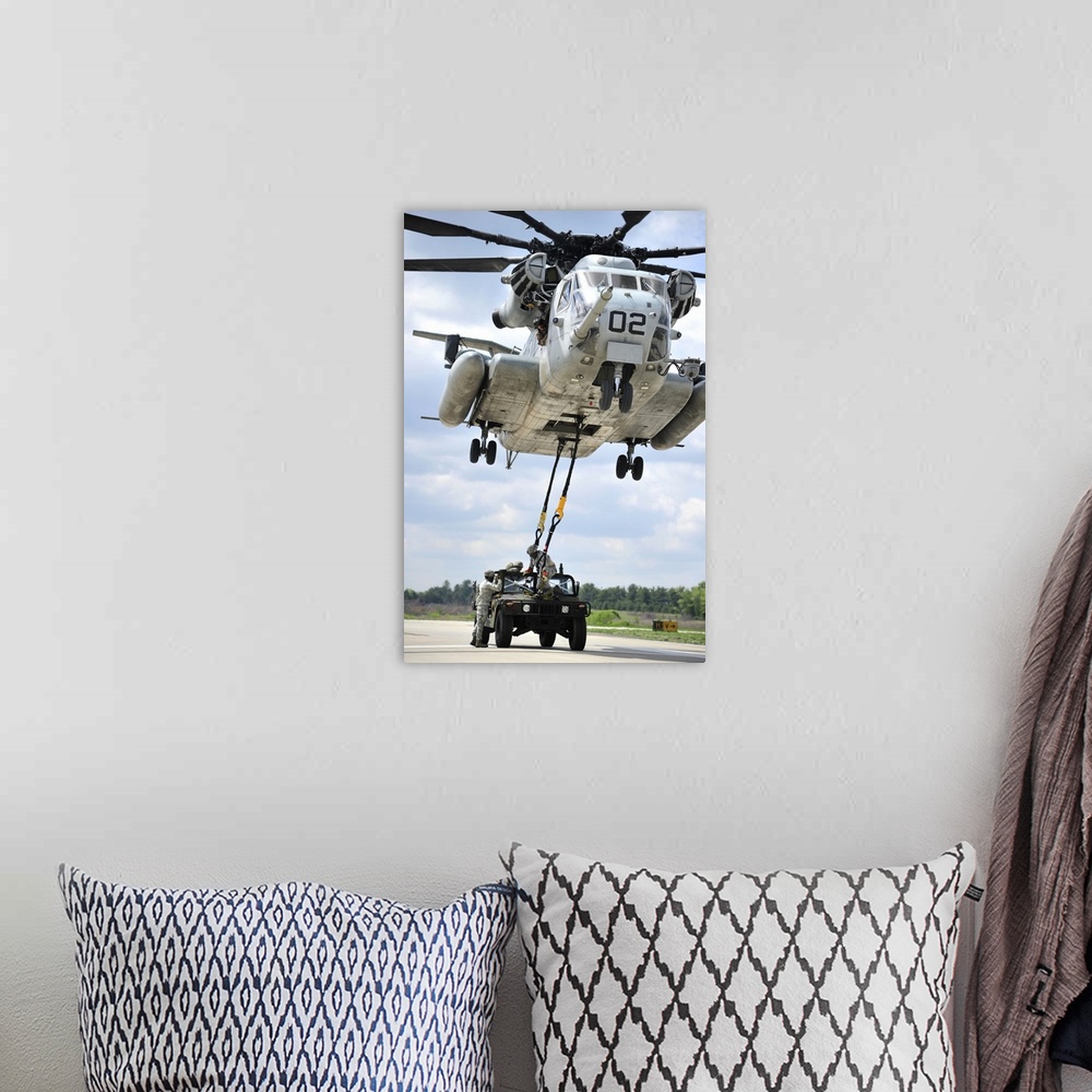 A bohemian room featuring U.S. Marines conduct a sling load operation with a CH-53E Super Stallion.
