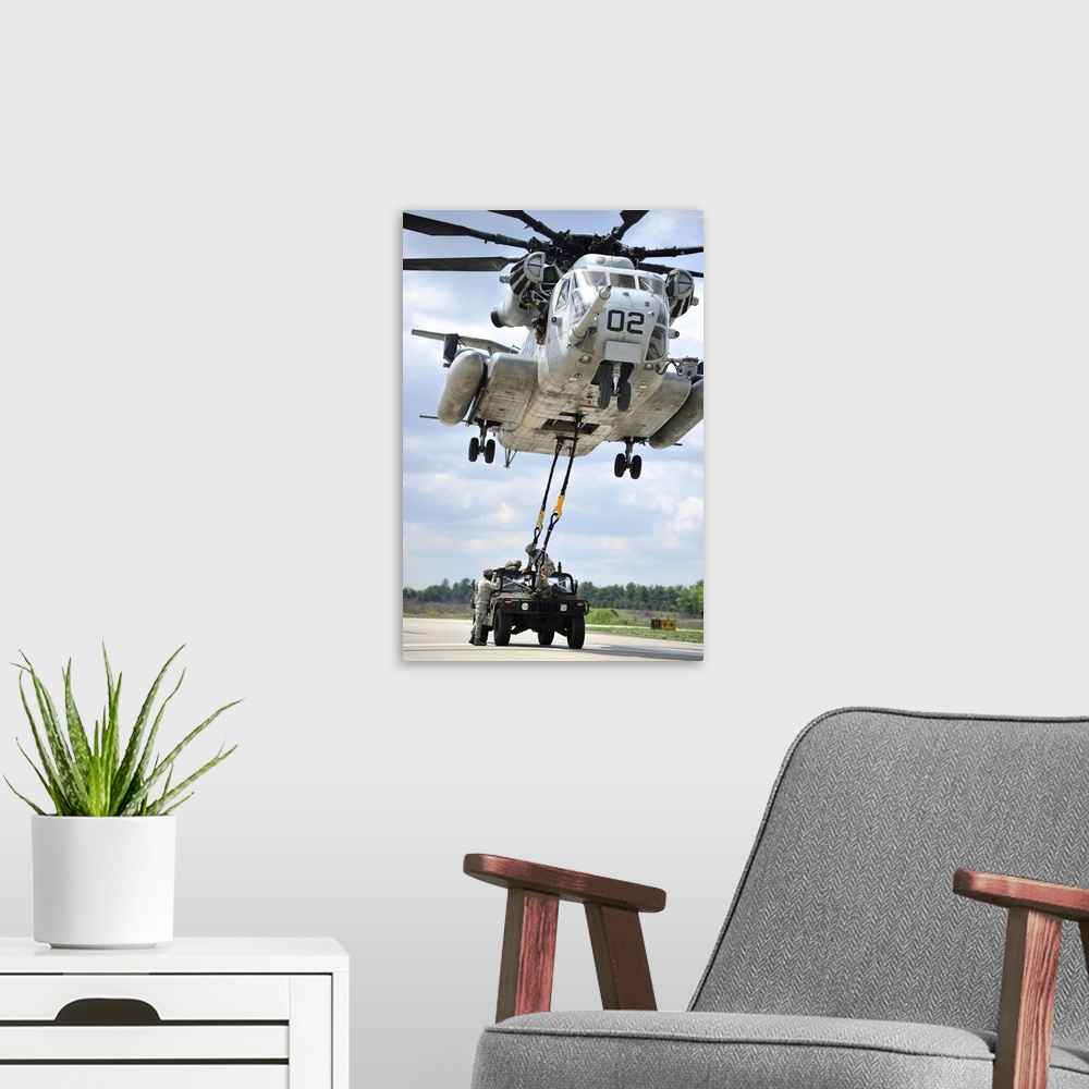 A modern room featuring U.S. Marines conduct a sling load operation with a CH-53E Super Stallion.