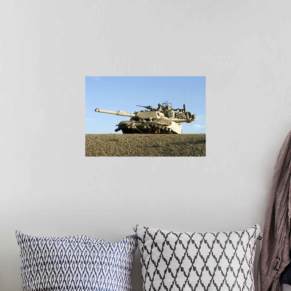 A bohemian room featuring US Marines provide security in an M1A1 Abrams tank
