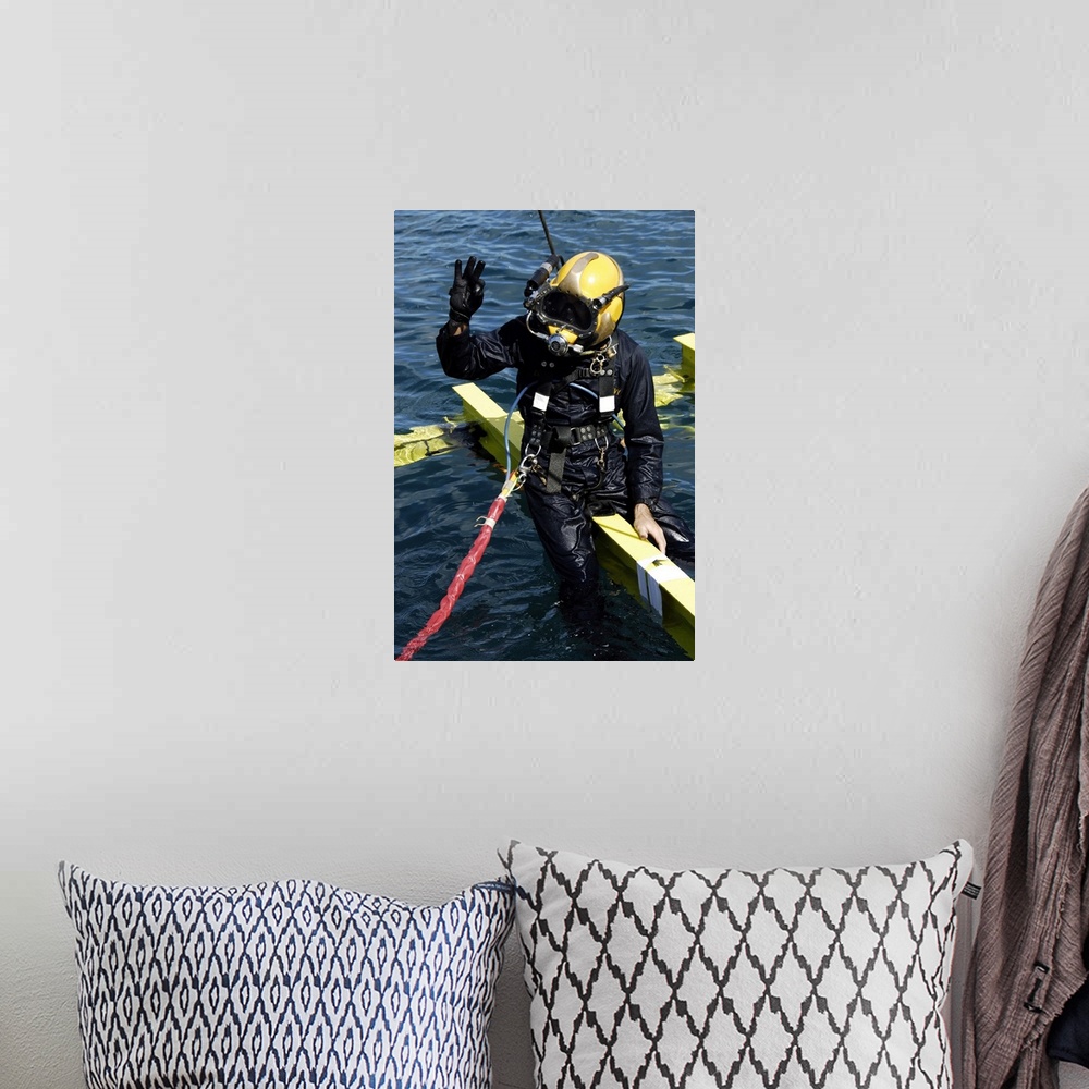 A bohemian room featuring February 1, 2007 - U.S. Navy Diver signals an OK sign to the dive supervisor on a dive station of...