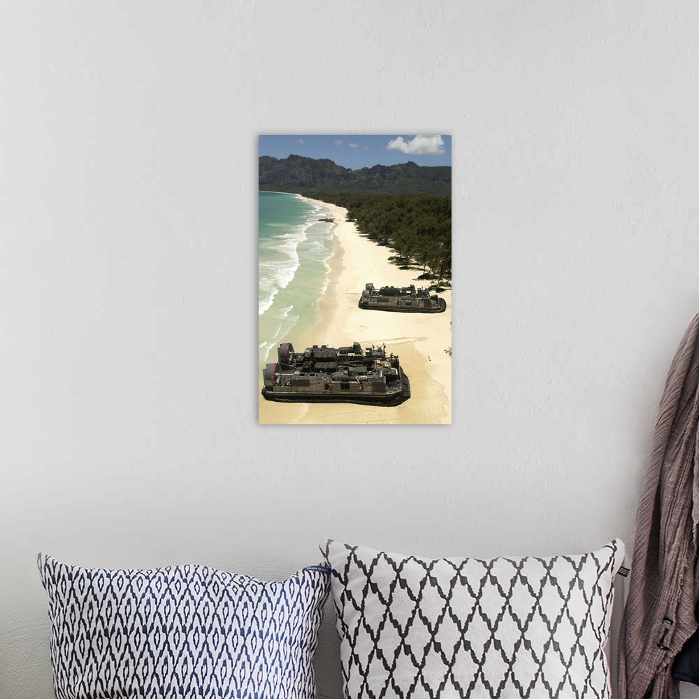 A bohemian room featuring US Navy Landing Craft land on the beach to offload equipment in Oahu Hawaii