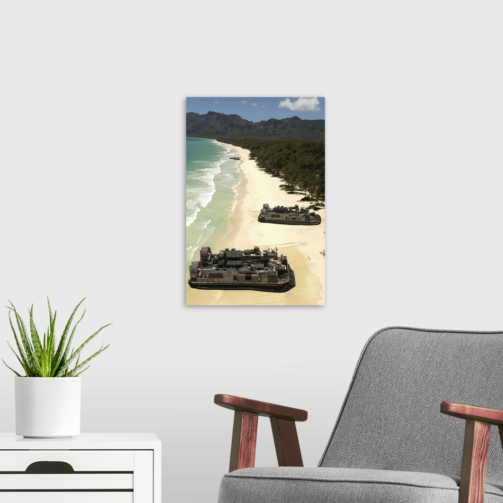A modern room featuring US Navy Landing Craft land on the beach to offload equipment in Oahu Hawaii