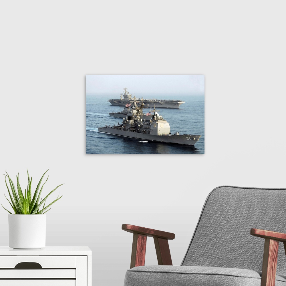 A modern room featuring USS Antietam, USS Nimitz, and USS Higgins transit through the Gulf of Oman.