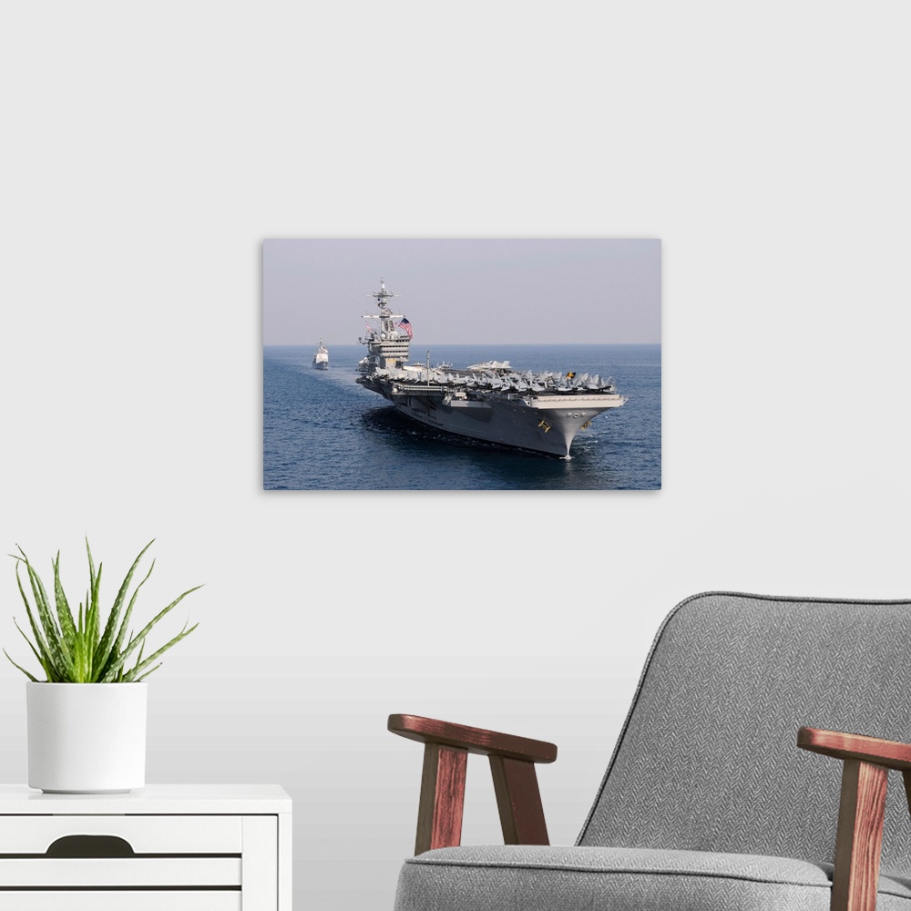 A modern room featuring USS Carl Vinson and USS Bunker Hill transit the Pacific Ocean.